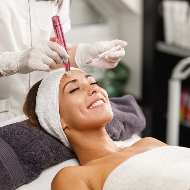 Shot of a beautiful young woman on a facial dermapen micro-needling treatment at the beauty salon.
